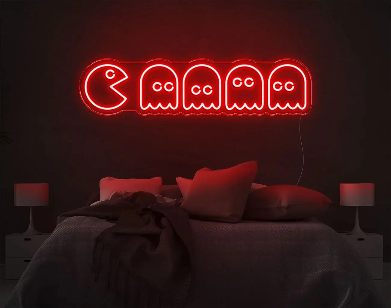 Enseigne LED néon Pacman rouge style arcade illuminant une chambre sombre.